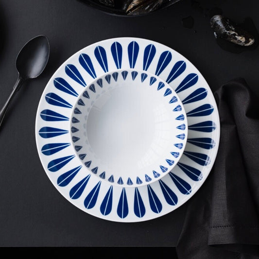 Elegant blue and white plate featuring the iconic Lotus pattern by Arne Clausen.