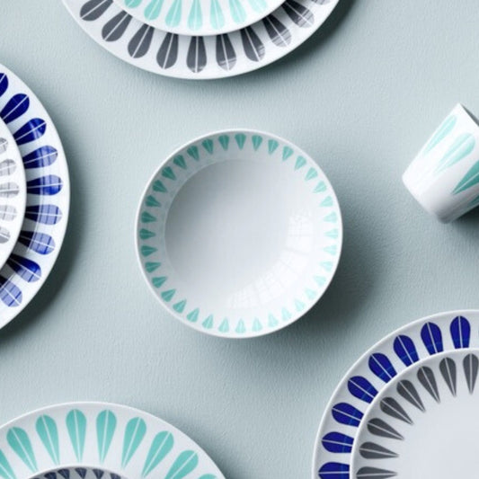 A set of blue and white plates and cups featuring the iconic ‘Lotus’ pattern by Arne Clausen. ARNE CLAUSEN COLLECTION, Lotus | White, grey, Bowls & plates.