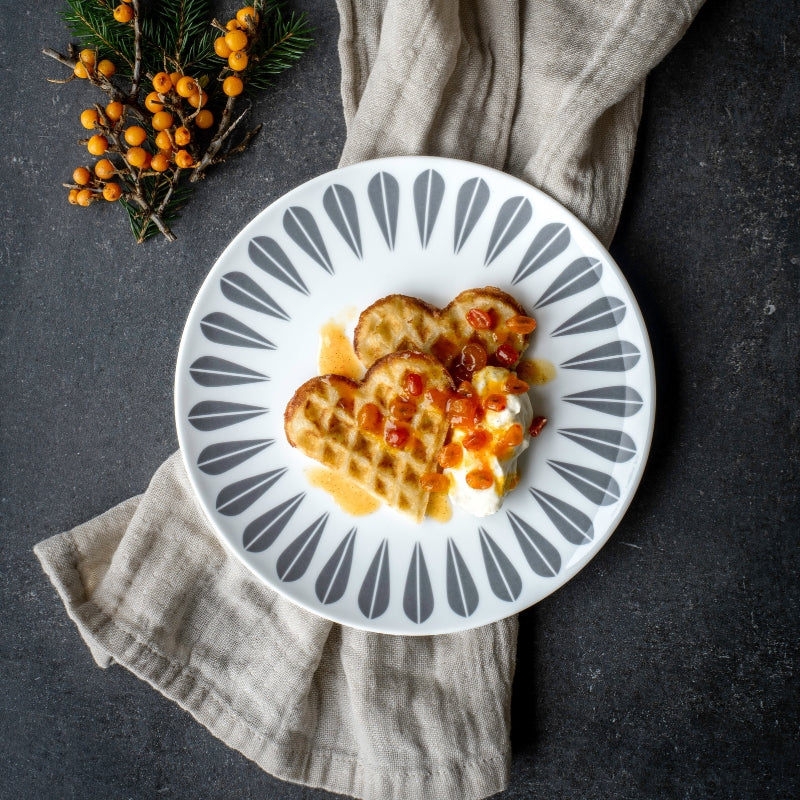 Arne Clausen's Lotus collection plate with waffles, honey, and orange slices.